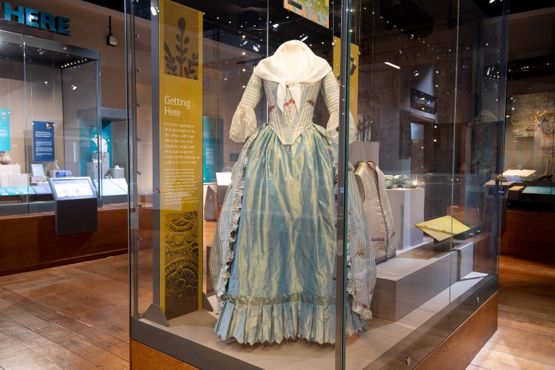 Image of a dress on display in a museum
