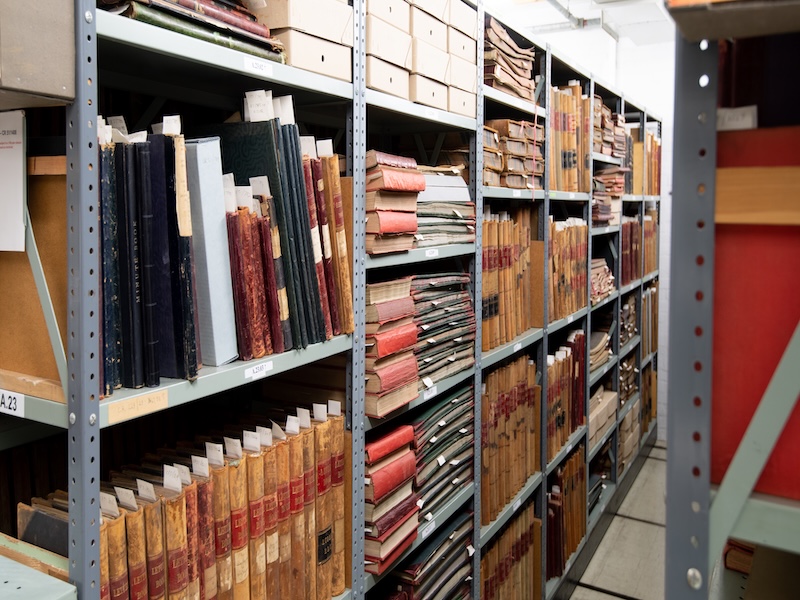 Image of books and documents on a shelf