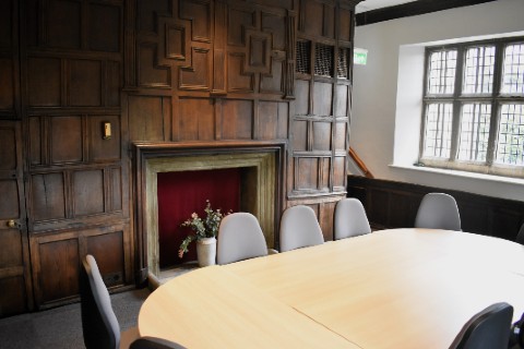 A round table in a room with a panelled wall