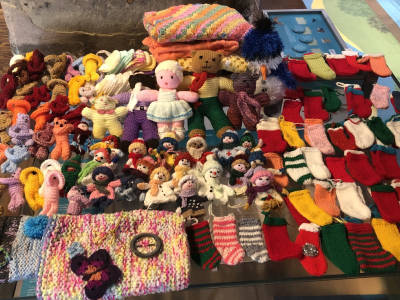 A large quantity of knitted items on display