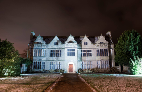 Photograph of St John's House Museum in Warwick illuminated by lights in the evening.
