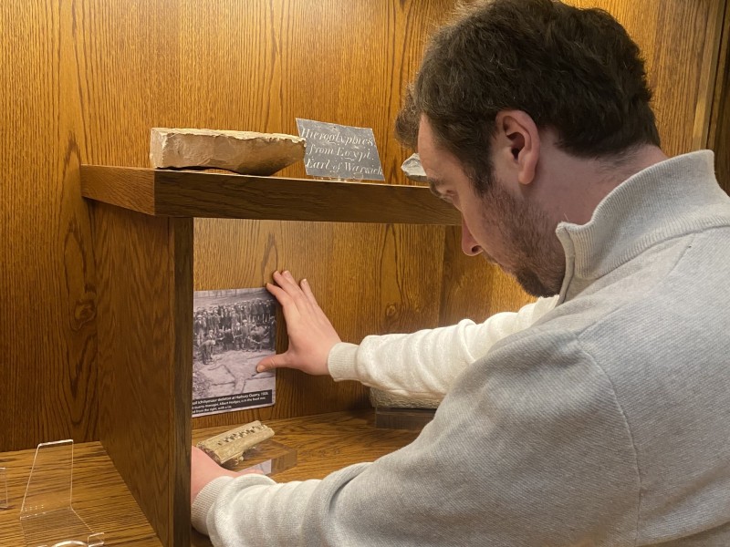 A volunteer arranging an exhibition display
