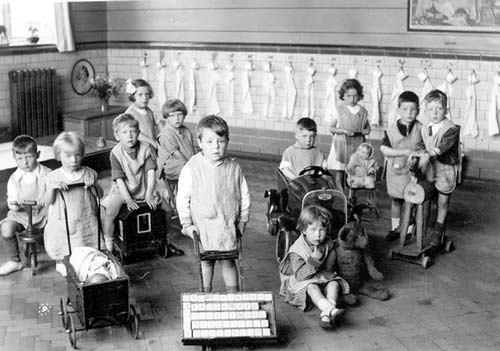 Black and white photo of some children playing with toys