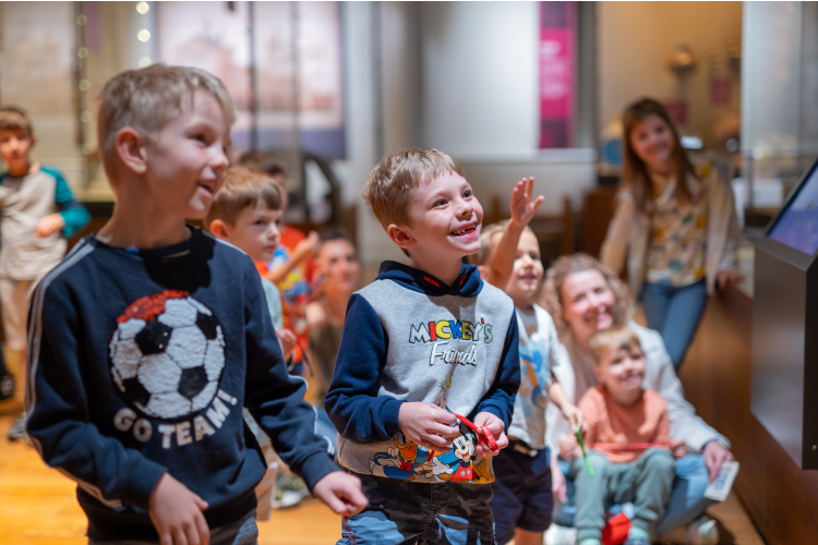 Group of children enjoying a show in Market Hall Museum
