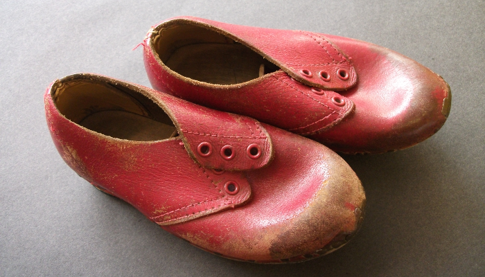 Worn red clogs