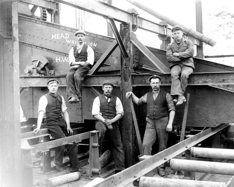 A black and white image of mineworkers from history