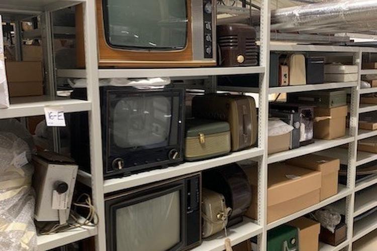 Image of old TVs and recording equipment in storage